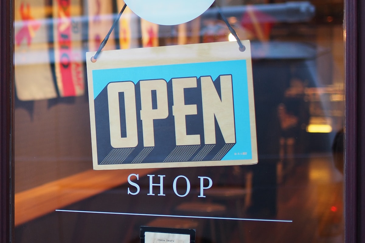 Pop-up shop with display products and customers browsing in a busy location